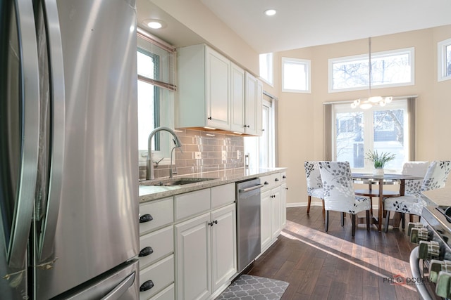 kitchen with sink, white cabinetry, tasteful backsplash, appliances with stainless steel finishes, and dark hardwood / wood-style flooring