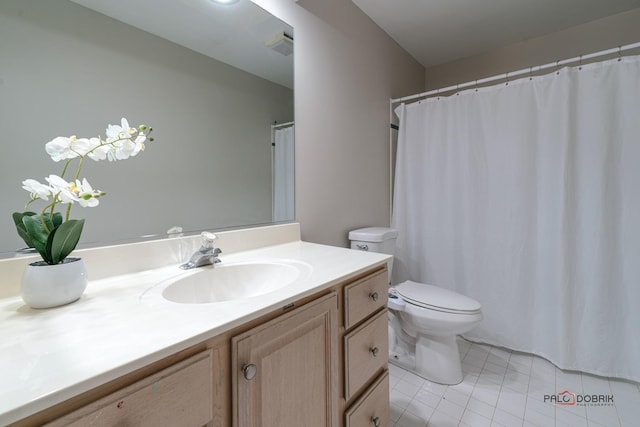 bathroom with tile patterned flooring, vanity, and toilet