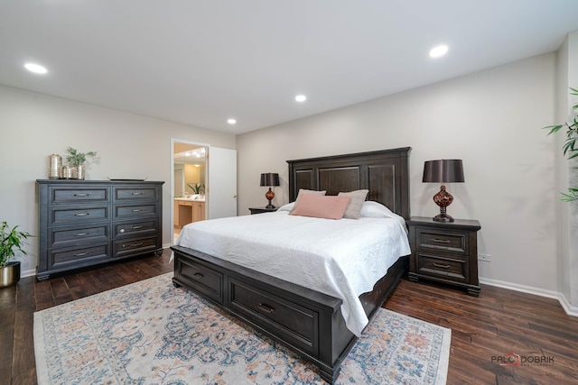 bedroom featuring dark hardwood / wood-style flooring and ensuite bath