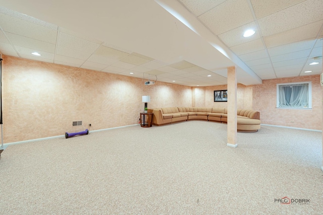 interior space with carpet floors and a drop ceiling