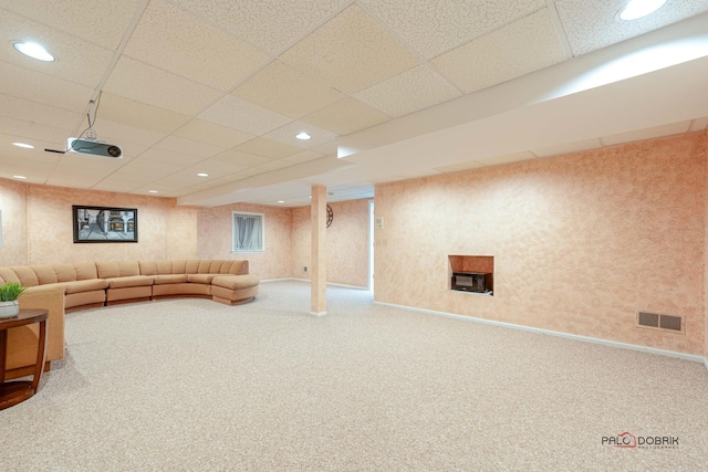 living room with carpet floors and a paneled ceiling