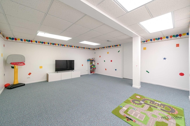 game room with a paneled ceiling and carpet flooring