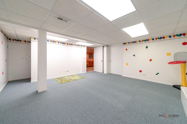 basement with carpet flooring and a drop ceiling