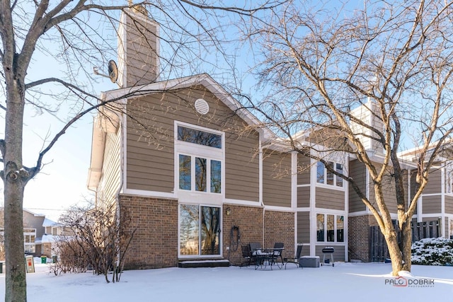 view of snow covered rear of property