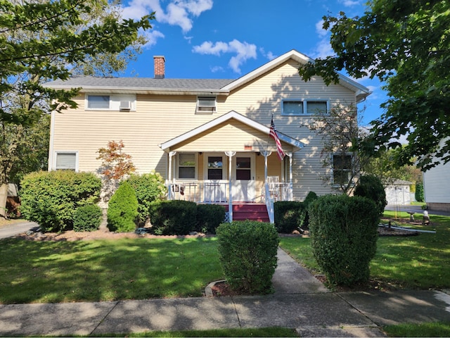 view of front of home with a porch and a front yard