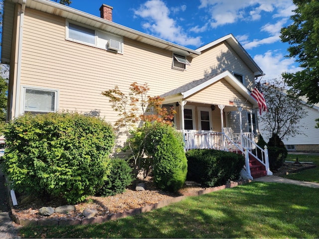 view of front of house with covered porch and a front yard