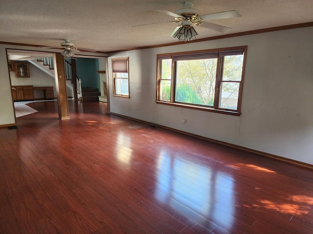 unfurnished room with hardwood / wood-style floors, a textured ceiling, ceiling fan, and ornamental molding