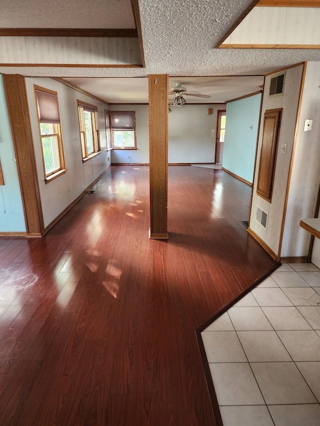 spare room with wood-type flooring, a textured ceiling, and ceiling fan