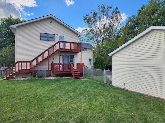 rear view of property featuring a wooden deck and a lawn