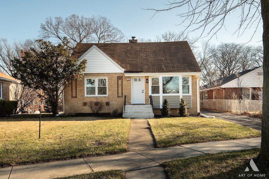 bungalow-style home with a front lawn