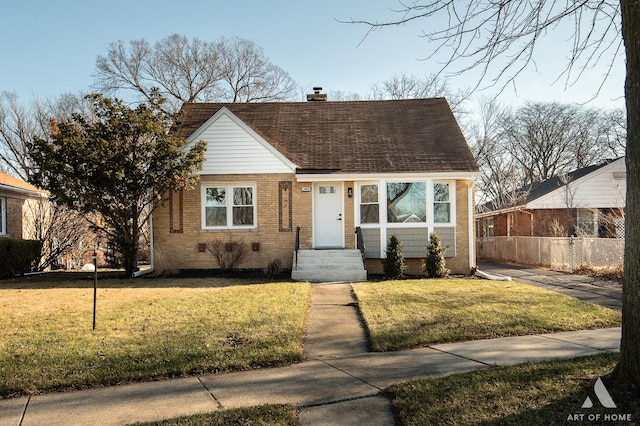 bungalow-style home with a front lawn