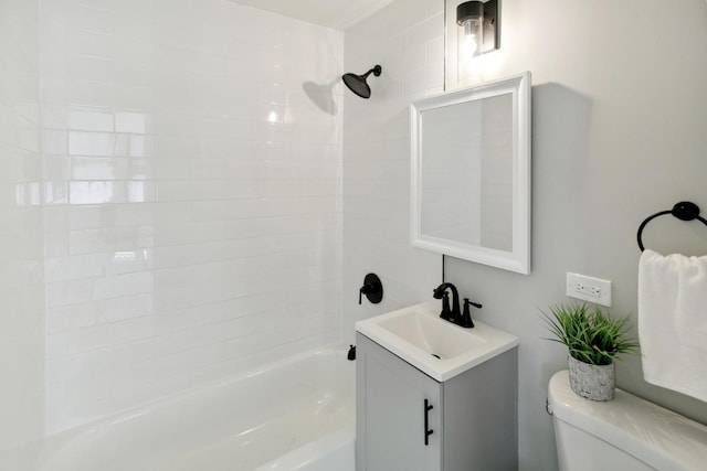 full bathroom featuring washtub / shower combination, vanity, and toilet