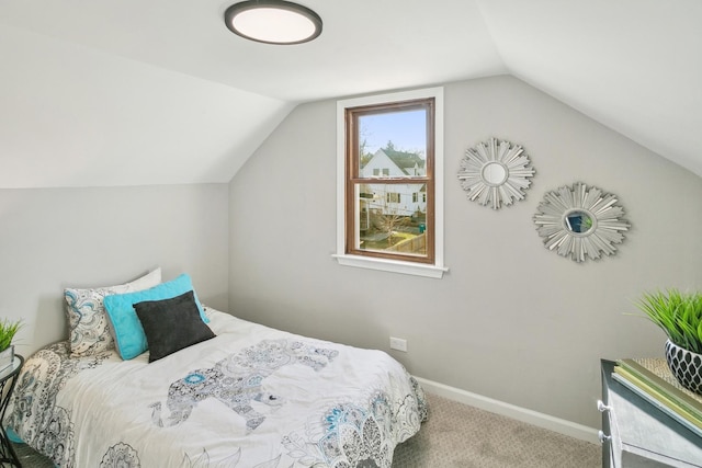 carpeted bedroom featuring lofted ceiling