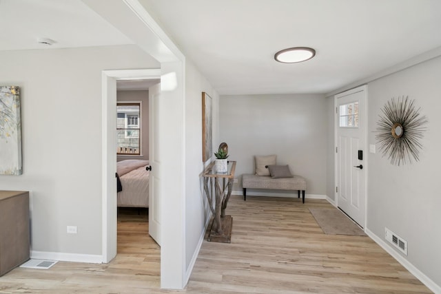 foyer entrance with light hardwood / wood-style floors