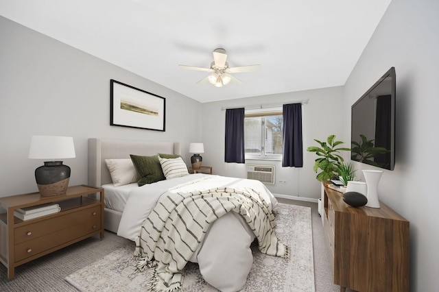 carpeted bedroom featuring an AC wall unit and ceiling fan