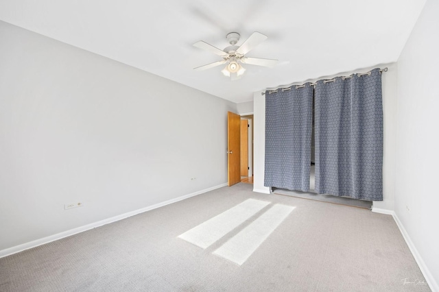 unfurnished bedroom featuring ceiling fan and light carpet