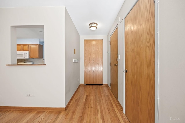 hall with light hardwood / wood-style flooring