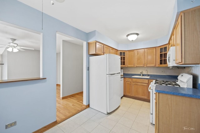 kitchen featuring sink, white appliances, ceiling fan, tasteful backsplash, and light tile patterned floors