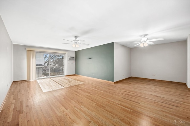 unfurnished living room with light wood-type flooring, ceiling fan, and a wall mounted air conditioner