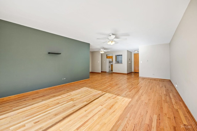 unfurnished living room featuring light wood-type flooring and ceiling fan