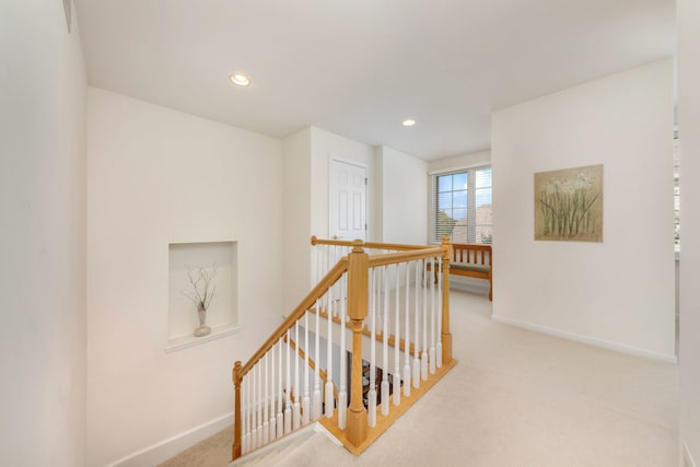 corridor featuring light colored carpet