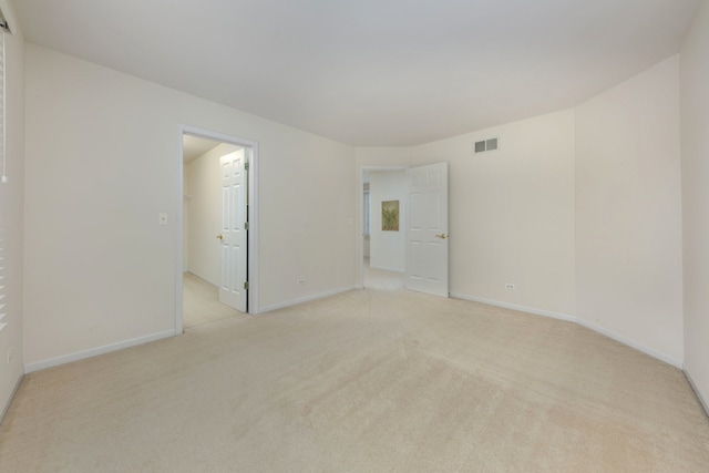 unfurnished room with light colored carpet