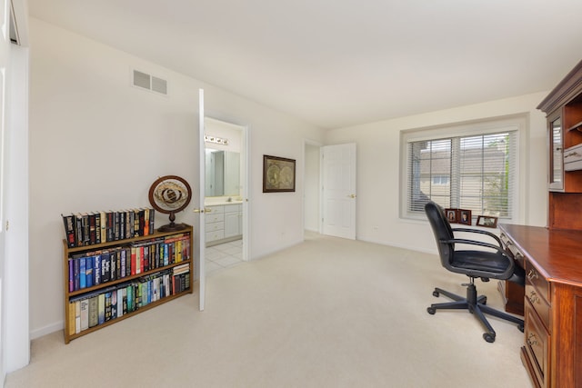 office area featuring light carpet