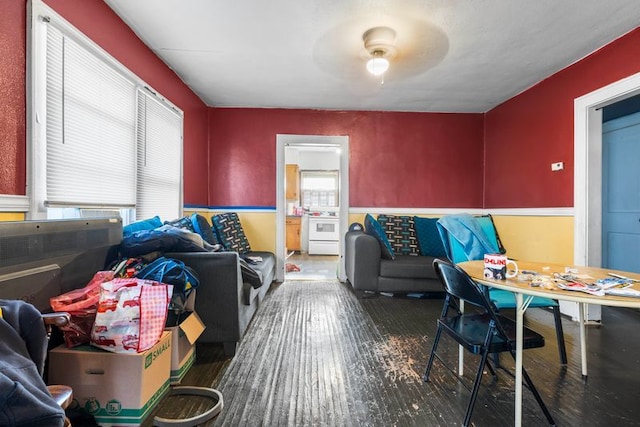 living room featuring ceiling fan and dark wood-type flooring