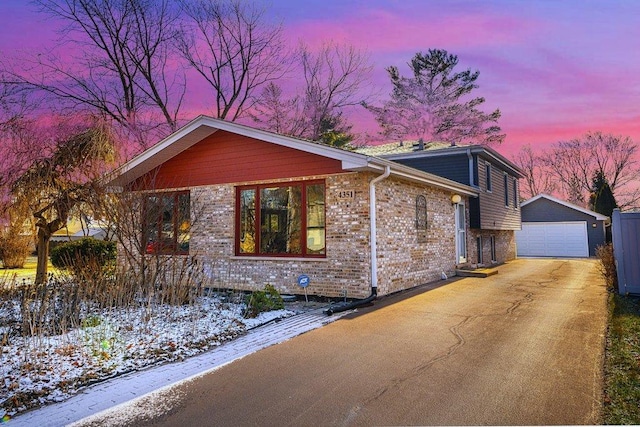 ranch-style house featuring a garage and an outdoor structure