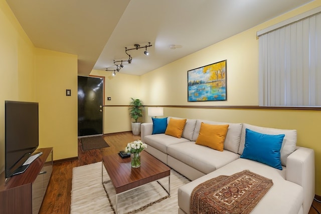 living room with hardwood / wood-style floors and track lighting