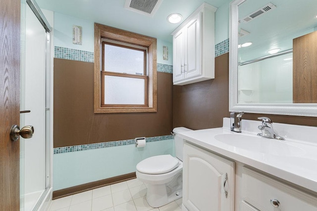 bathroom featuring tile patterned floors, vanity, toilet, and a shower with shower door