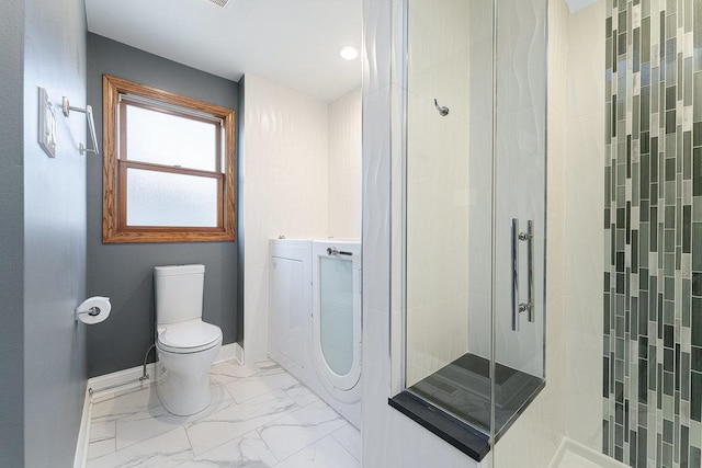 bathroom with tiled shower and toilet