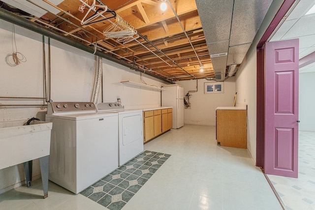 laundry area with washer and dryer and cabinets