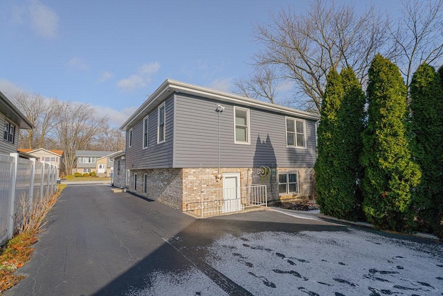 back of house with central AC unit