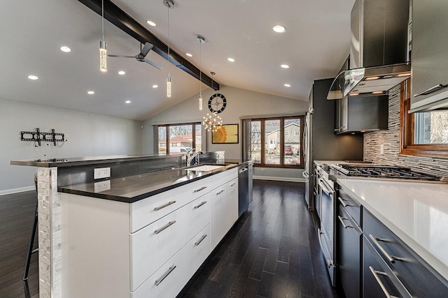 kitchen with backsplash, white cabinetry, sink, and decorative light fixtures