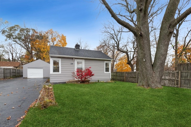 view of front of property with a garage and a front yard