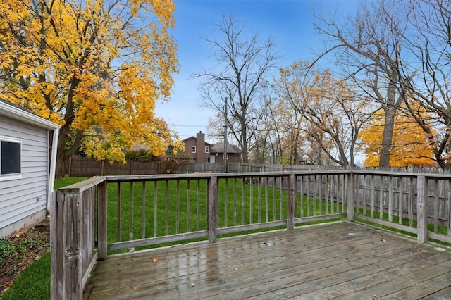 wooden terrace with a lawn