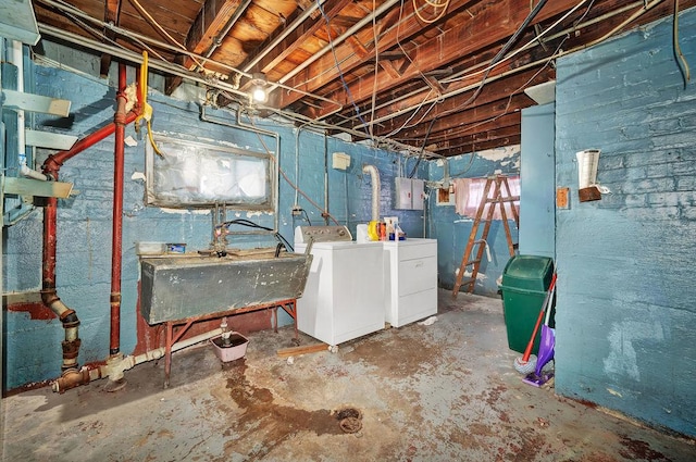 basement with washing machine and clothes dryer and sink