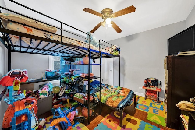 bedroom with wood-type flooring and ceiling fan