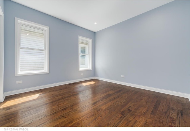 spare room featuring dark hardwood / wood-style floors