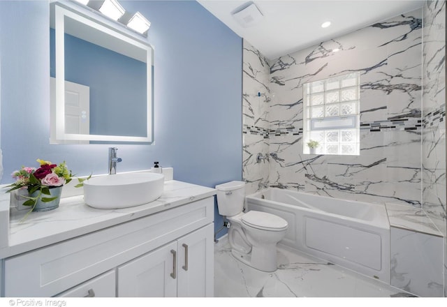 full bathroom featuring vanity, tiled shower / bath combo, and toilet