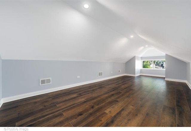 additional living space featuring vaulted ceiling and dark hardwood / wood-style floors