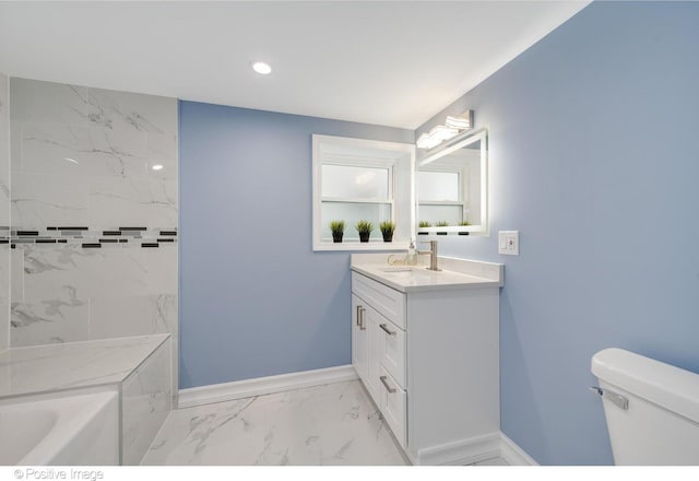 bathroom featuring a bath, vanity, and toilet