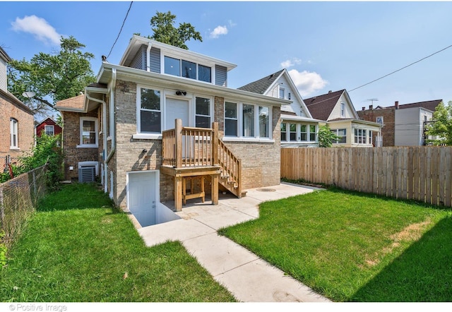 view of front of property featuring a front lawn and central AC unit