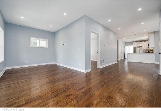 unfurnished living room with dark hardwood / wood-style floors