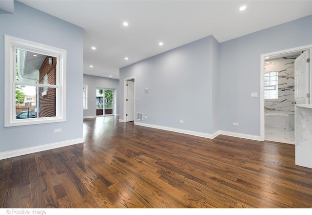 unfurnished living room with dark hardwood / wood-style floors