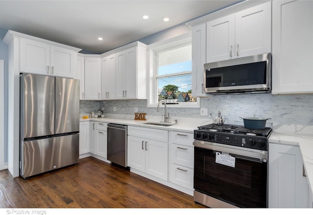 kitchen featuring sink, white cabinets, dark wood-type flooring, and appliances with stainless steel finishes