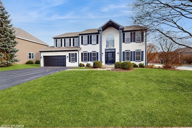 colonial inspired home with a garage and a front yard