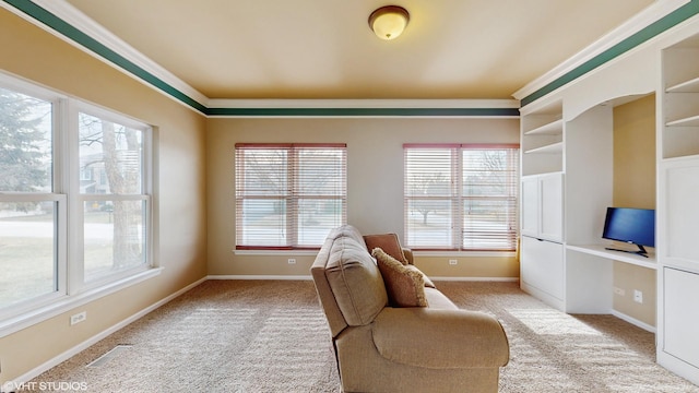 sitting room featuring plenty of natural light, light colored carpet, and ornamental molding