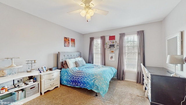 bedroom with light carpet and ceiling fan